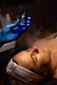 A woman is getting a facial treatment in a spa.