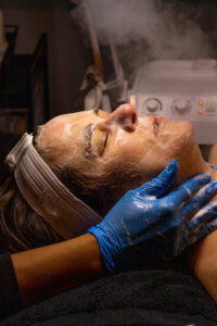 A woman getting a facial treatment in a spa.