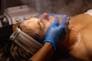 A woman getting a facial treatment in a spa.