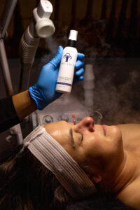 A woman is getting a facial treatment.