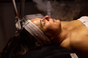 A woman lying on a bed with steam coming out of her head.