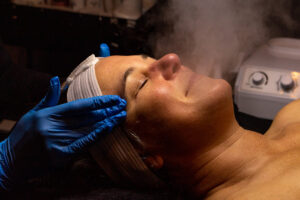 A woman getting a steam treatment in a salon.