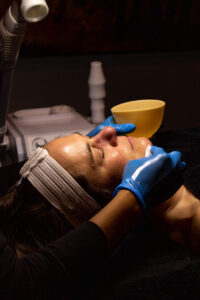 A woman getting a facial treatment.