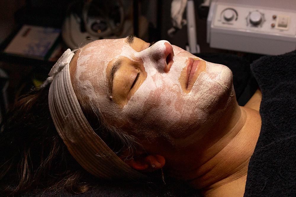A woman with a facial mask on her face.