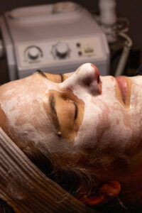 A woman getting a facial treatment at a spa.