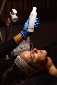 A woman getting a facial treatment in a salon.