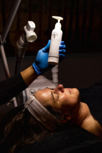A woman is getting a facial treatment at a salon.