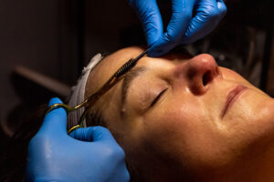 A woman getting her eyebrows waxed.
