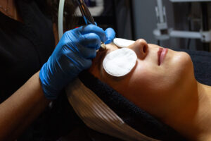 A woman getting a facial treatment in a salon.
