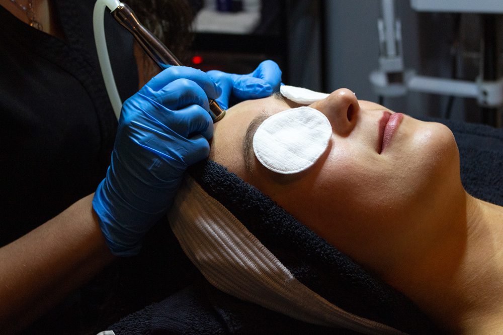 A woman getting a facial treatment at a spa.