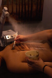 A woman getting a steam treatment at a spa.