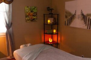 A room with a massage table and candles.