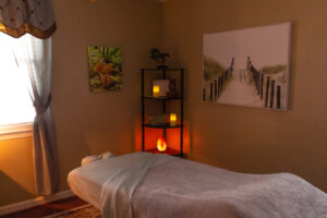 A room with a massage table and candles.