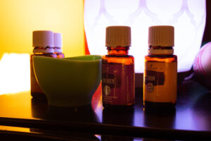 Three bottles of essential oils on a table.