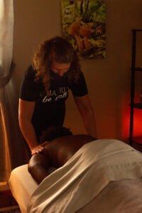 A man is getting a massage in a room.