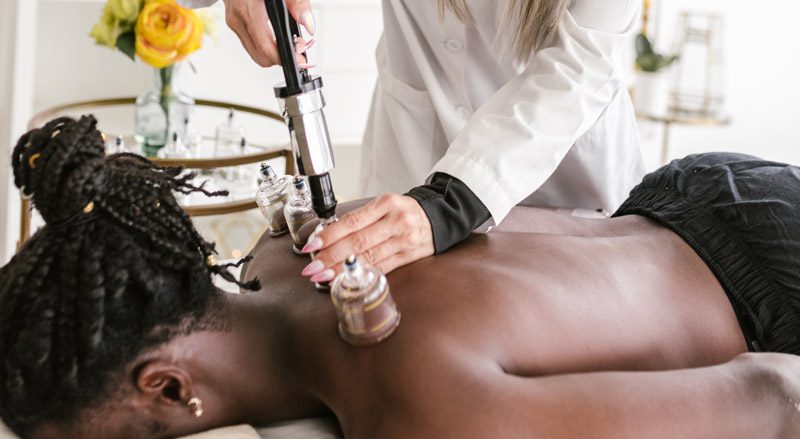 A woman getting a back massage at a spa.